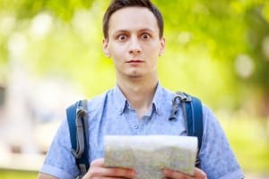 student with backpack looking at a map