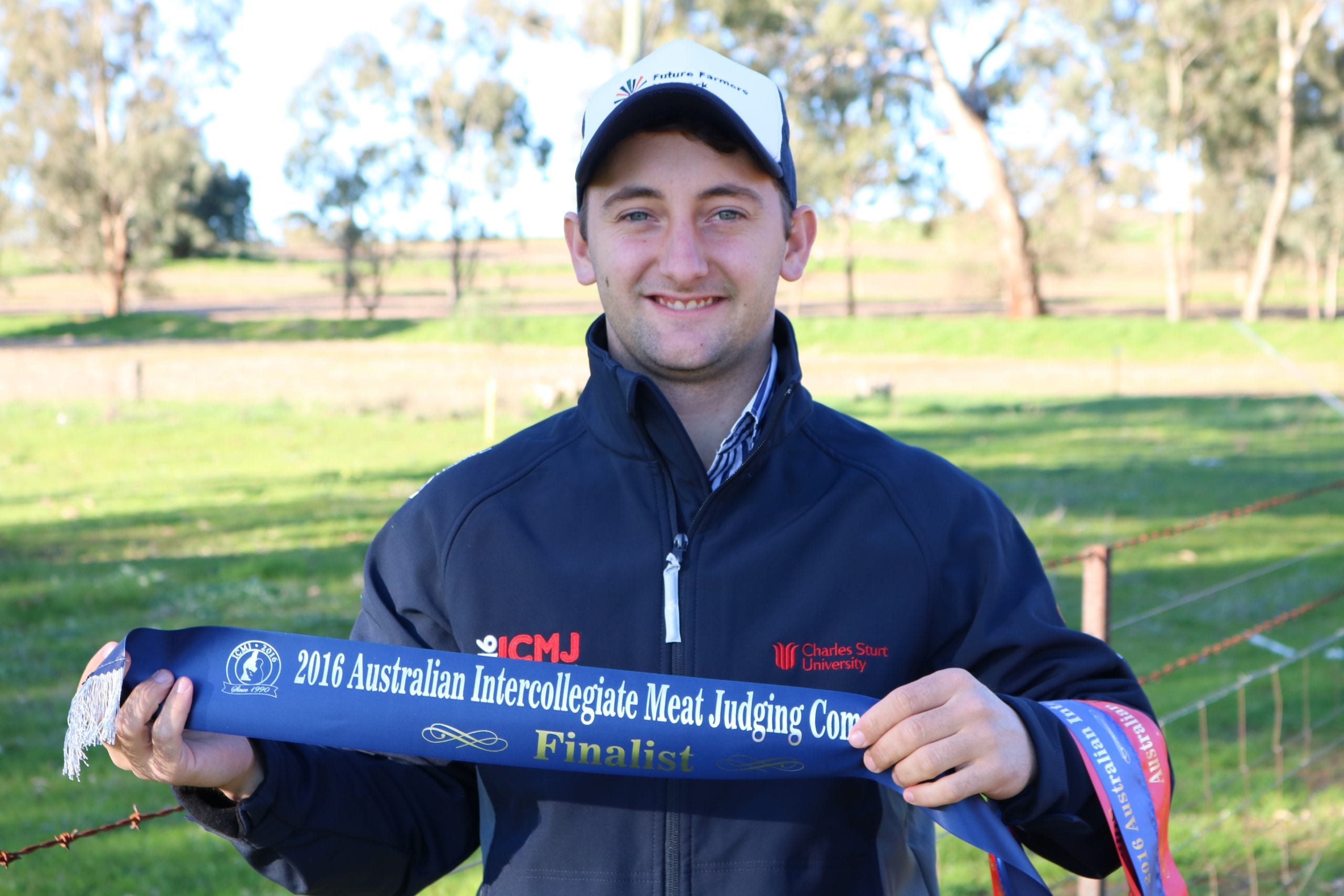 Macky Lawrence with meat judging competition ribbon
