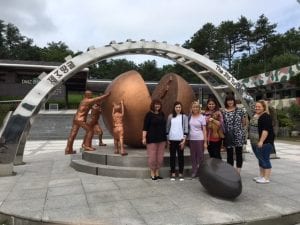 CSU social work students standing in front of historic sculpture in South Korea