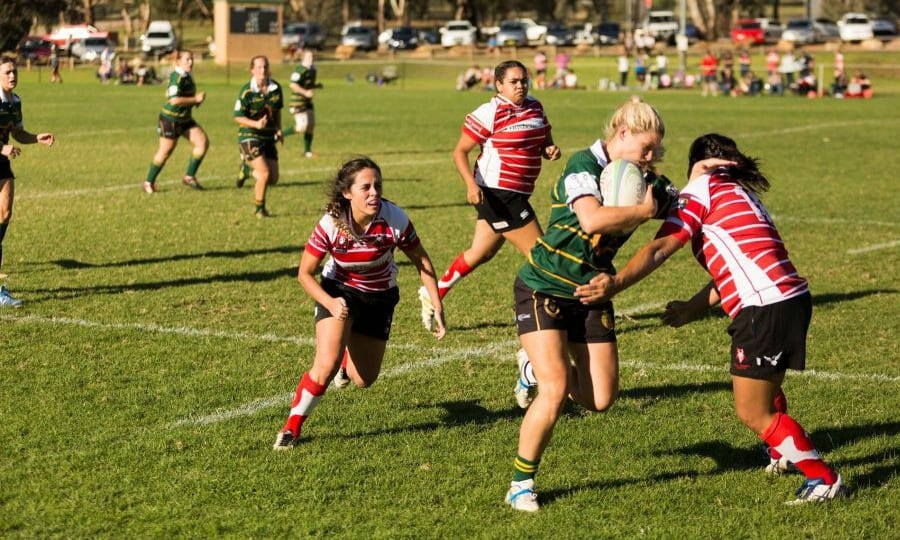 Elite Athlete Harriet Elleman makes a break in a women's rugby match