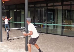 Two students playing tennis