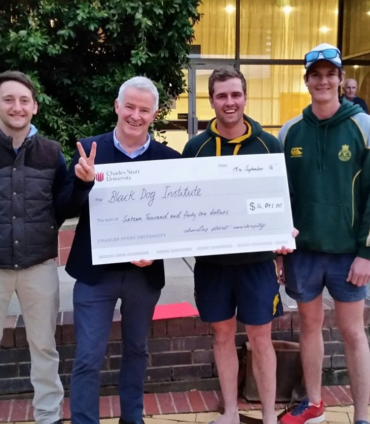 CSU fundraisers proudly hold a cheque to be donated to charity