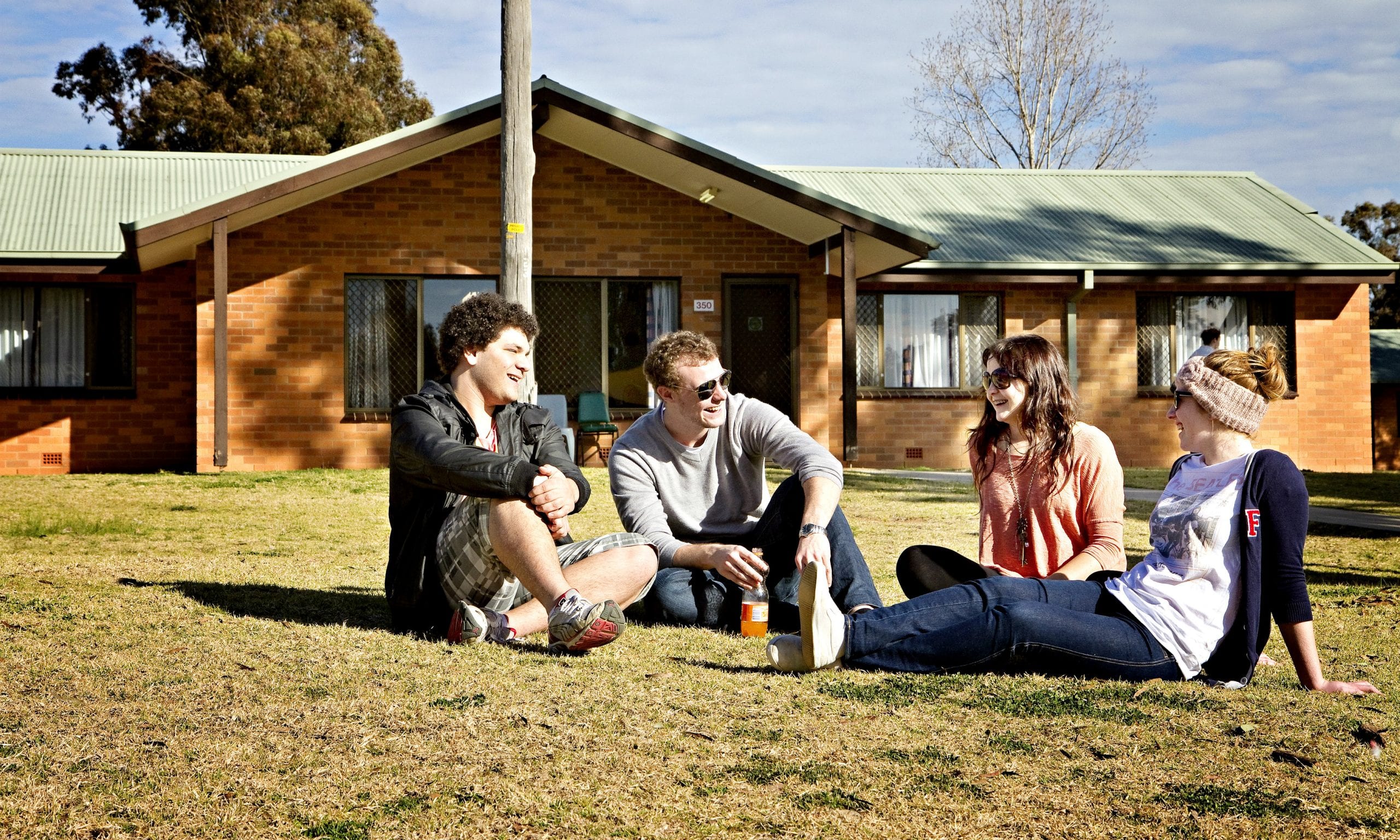 Students sitting outside campus accommodation