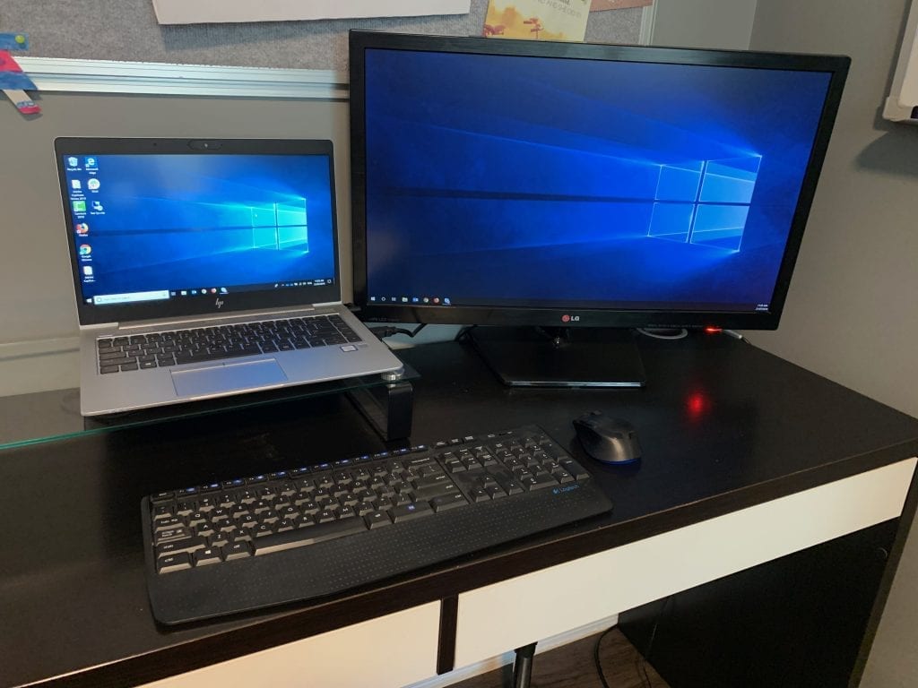 Laptop on desk with an additional monitor plugged in