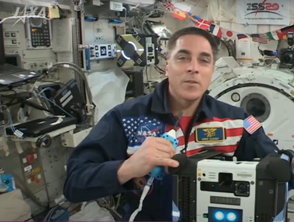 Astronaut Chris Cassidy speaks to the competition finalists from the International Space Station