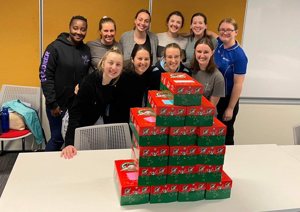 Operation Christmas Child: UBS Members packing shoeboxes full of items for children in need.