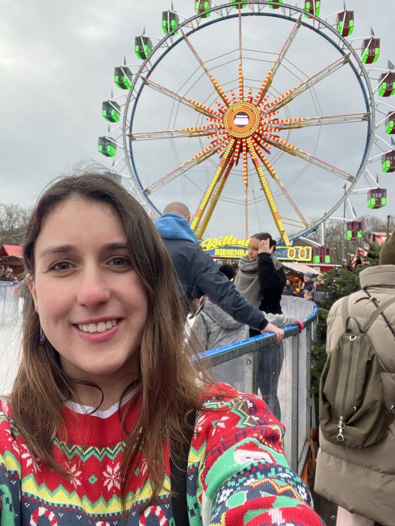 Mikayla and the Alexanderplatz Ferris Wheel and Ice-Skating Rink.