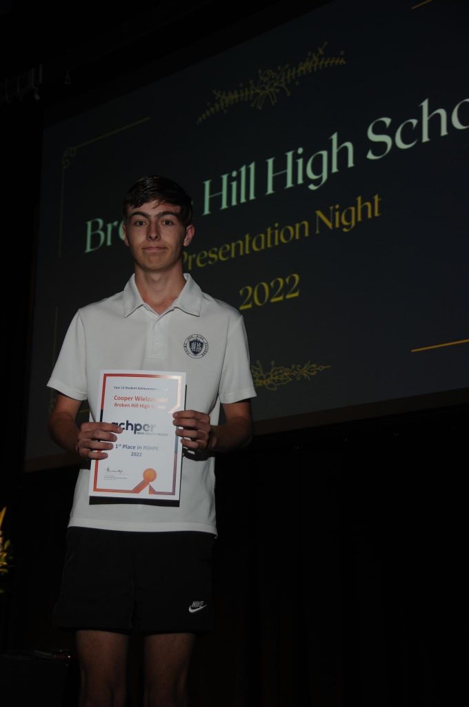 Cooper winning an award for First Place in PDHPE for Year 12.