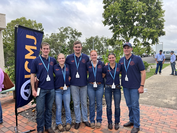 Six students standing in a line in their Meat Judging uniform.