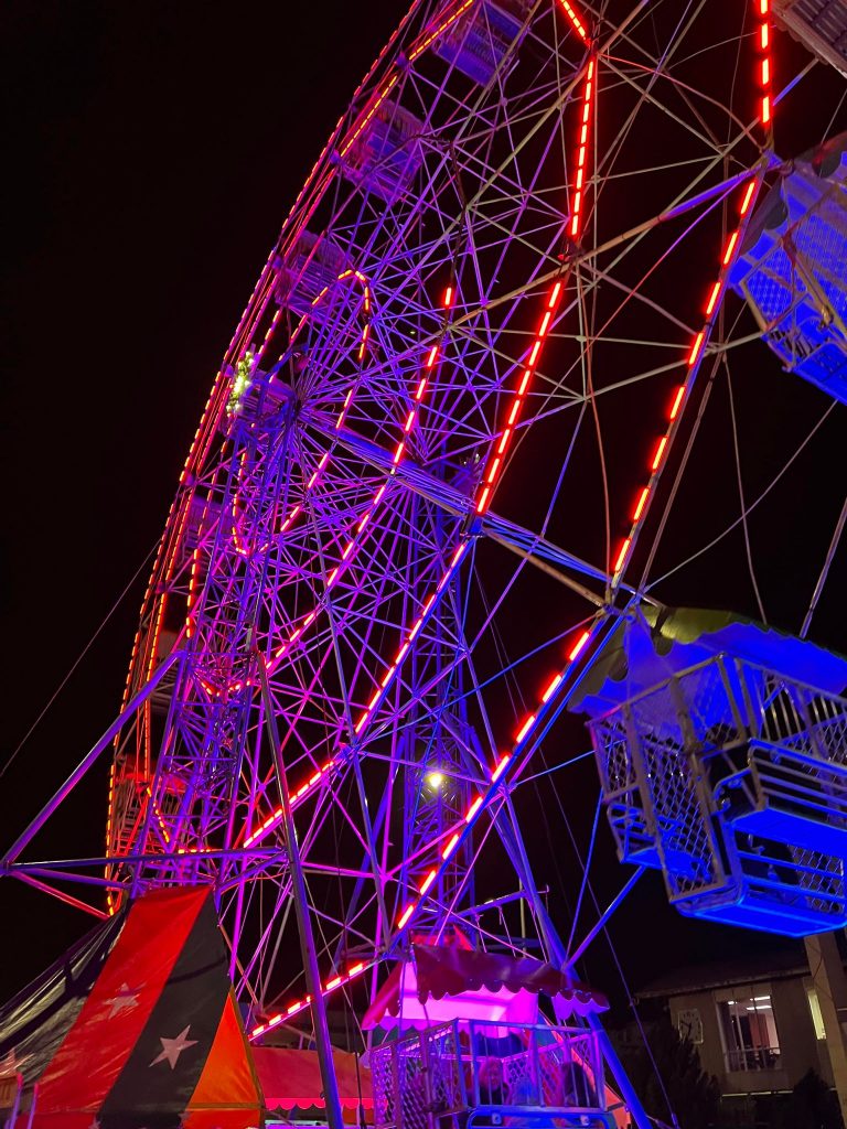 The Ferris Wheel lit up at night.